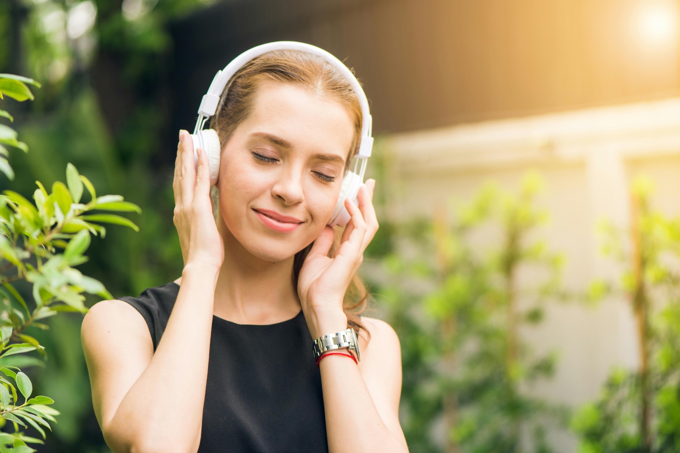 Guest listening with headphones in warm daylight